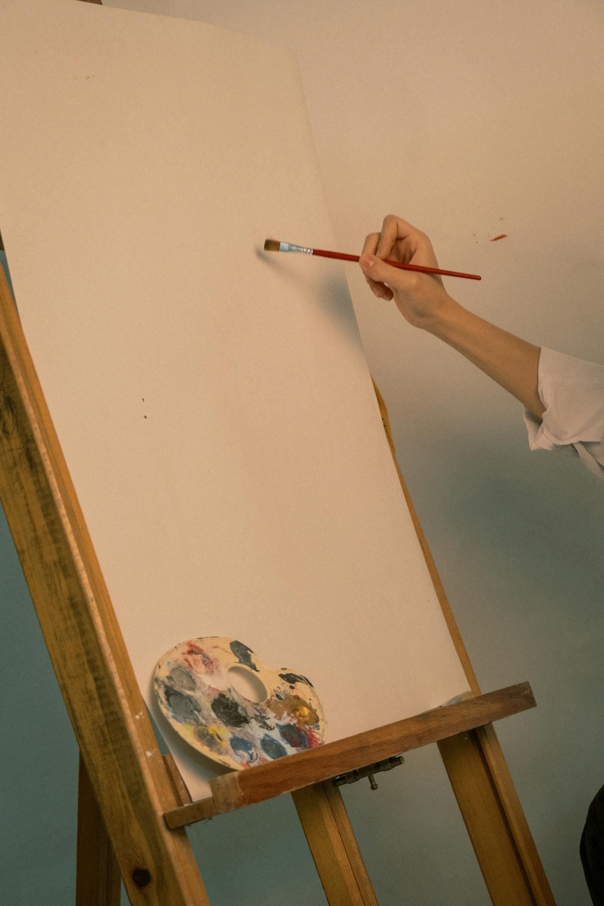 Painter at the easel, brush mid-stroke